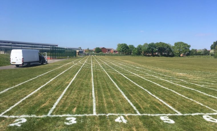 athletics track on natural grass, athletics line marking, 100mm sprint line marking in Swansea