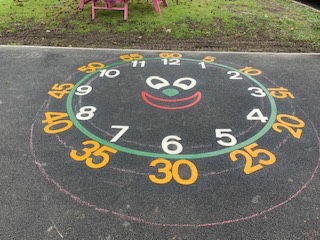 smiley clock face with minutes and hours installed in schools in merthyr